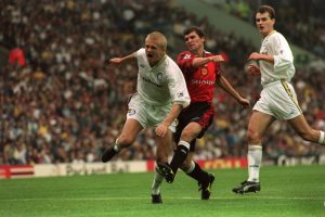 Manchester United's Roy Keane (centre) kicks Leeds United's Alf-Inge Haaland (left) as David Wetherall of Leeds United (right) looks on (Photo by Peter Wilcock/EMPICS via Getty Images)