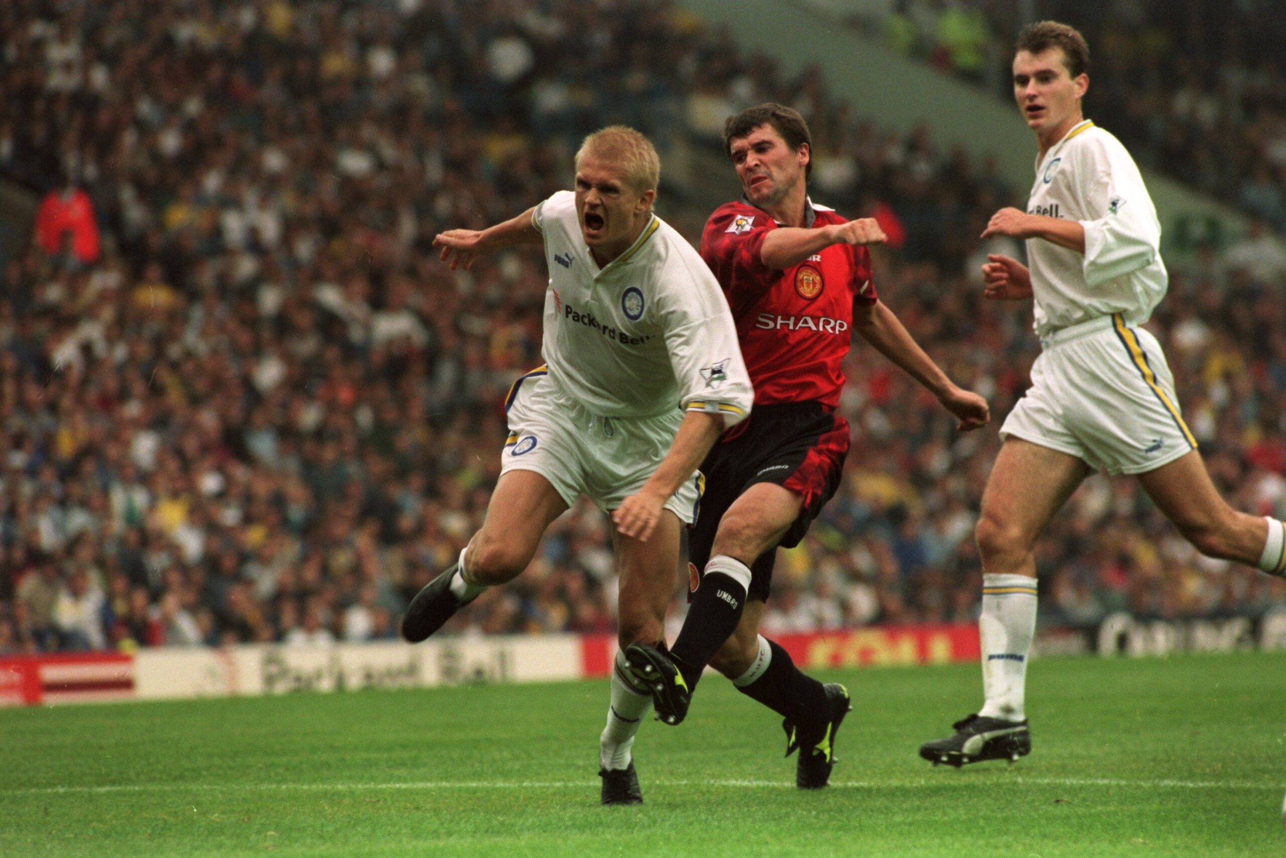 Manchester United's Roy Keane (centre) kicks Leeds United's Alf-Inge Haaland (left) as David Wetherall of Leeds United (right) looks on (Photo by Peter Wilcock/EMPICS via Getty Images)